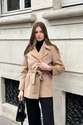 a lady in a brown  wool wrap coat and a pair of black pants
